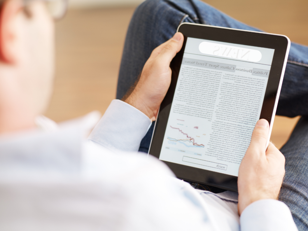 An image of someone reading the news on an ipad