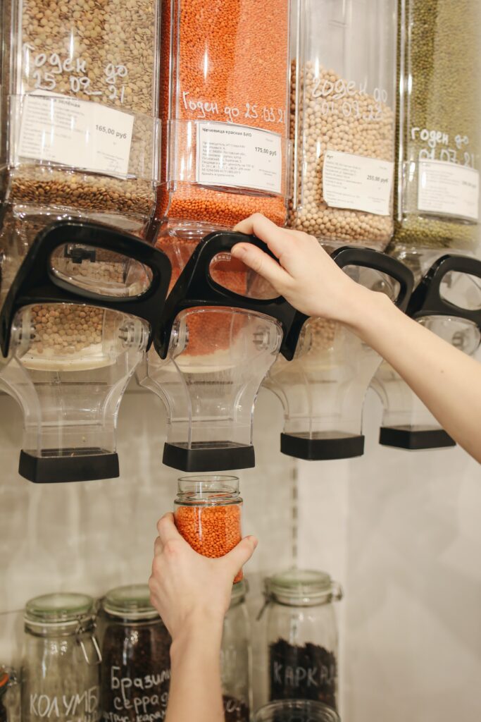 pouring red lentils into glass jar